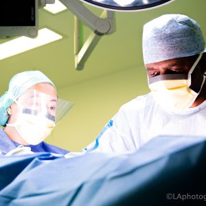 Photo in UCLH theatres, of scrub practtioner and surgeon at work