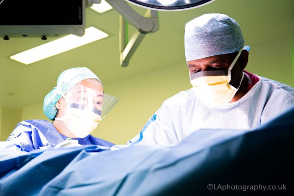 Photo in UCLH theatres, of scrub practtioner and surgeon at work